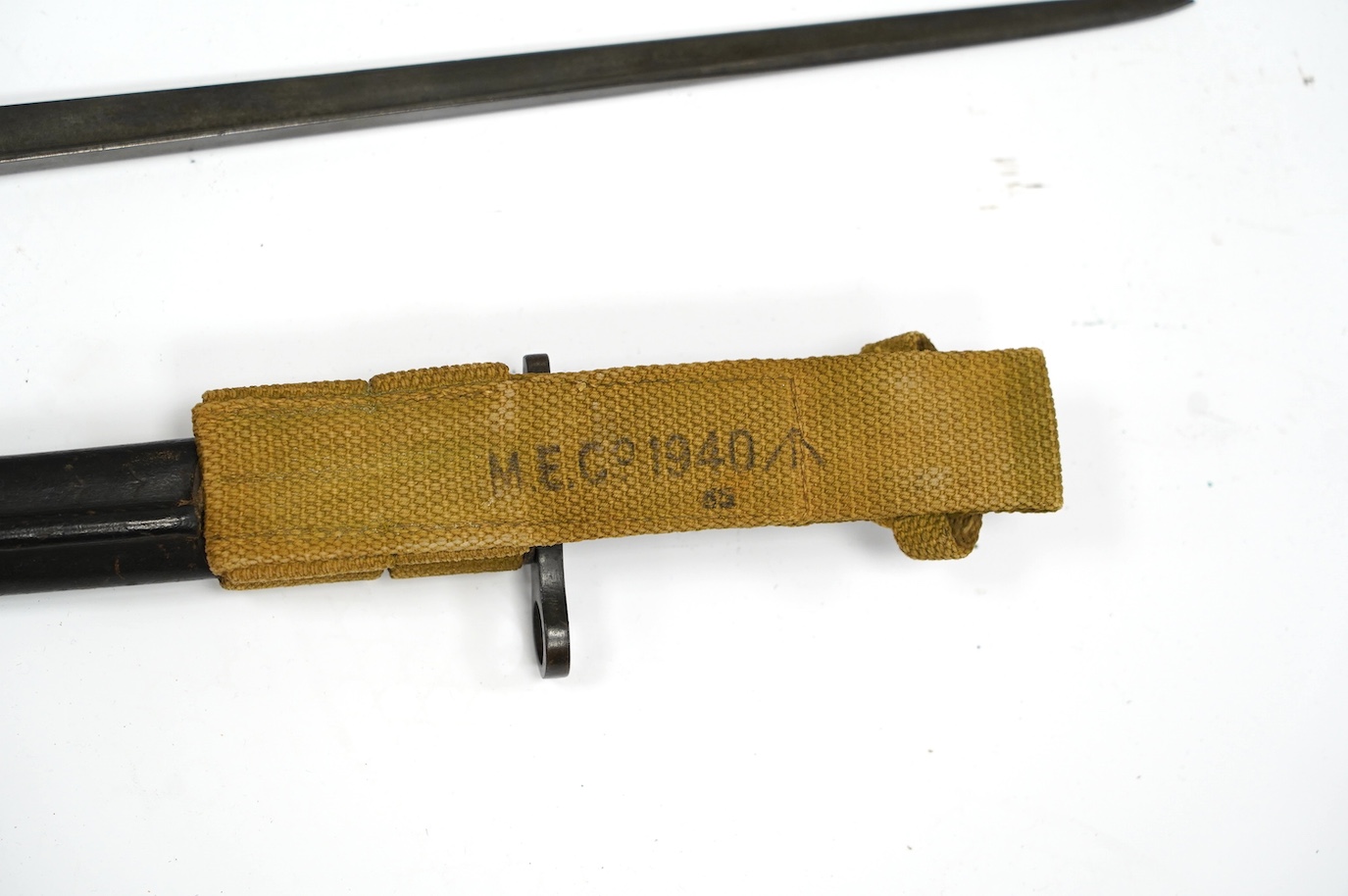 Two bayonets; a good Remington bayonet dated 1913 in its leather scabbard with khaki frog dated 1940, and a Gras bayonet dated 1880. Condition - good